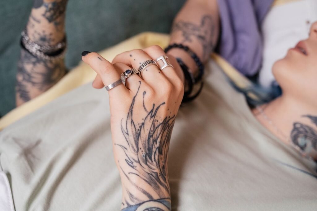 Mastering the First Impression: Your intriguing post title goes here A close-up of a tattooed hand with silver rings, showcasing intricate designs and fashion.